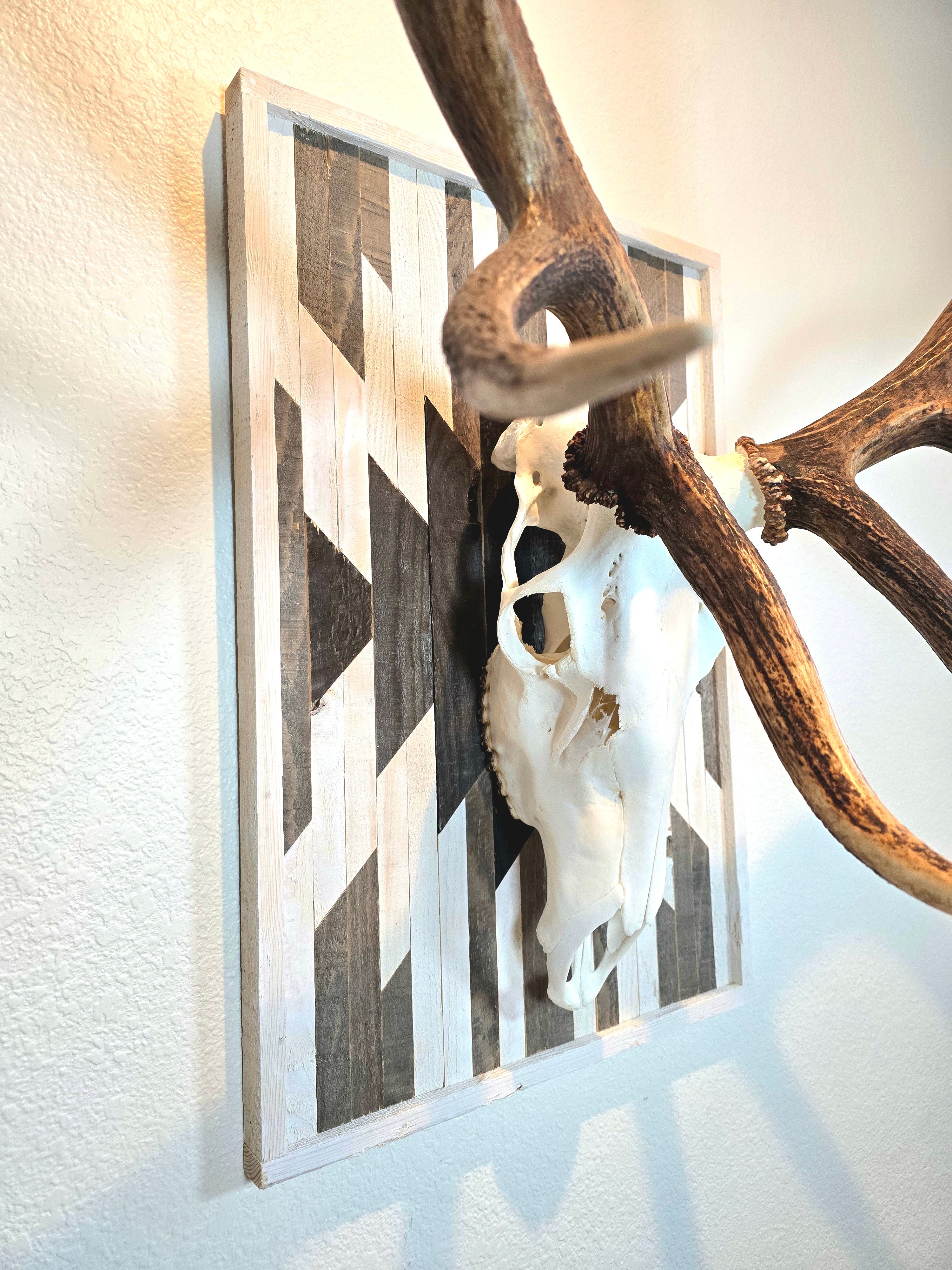 Aztec-inspired euro mount plaque with a geometric pattern, attached to a wall behind a skull trophy.